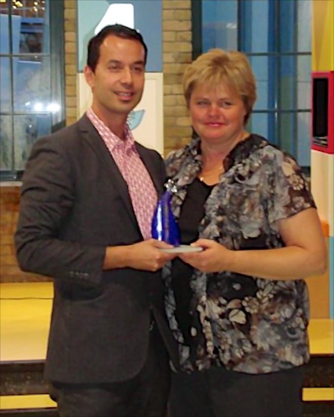 A man and a woman holding the award