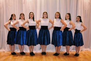 7 Girls dressed in white and blue 